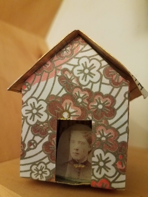 small folded paper house with intricate design